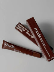 Rhode peptide lip tint Espresso Rich Brown on lips delivers natural glossy color and subtle fullness.