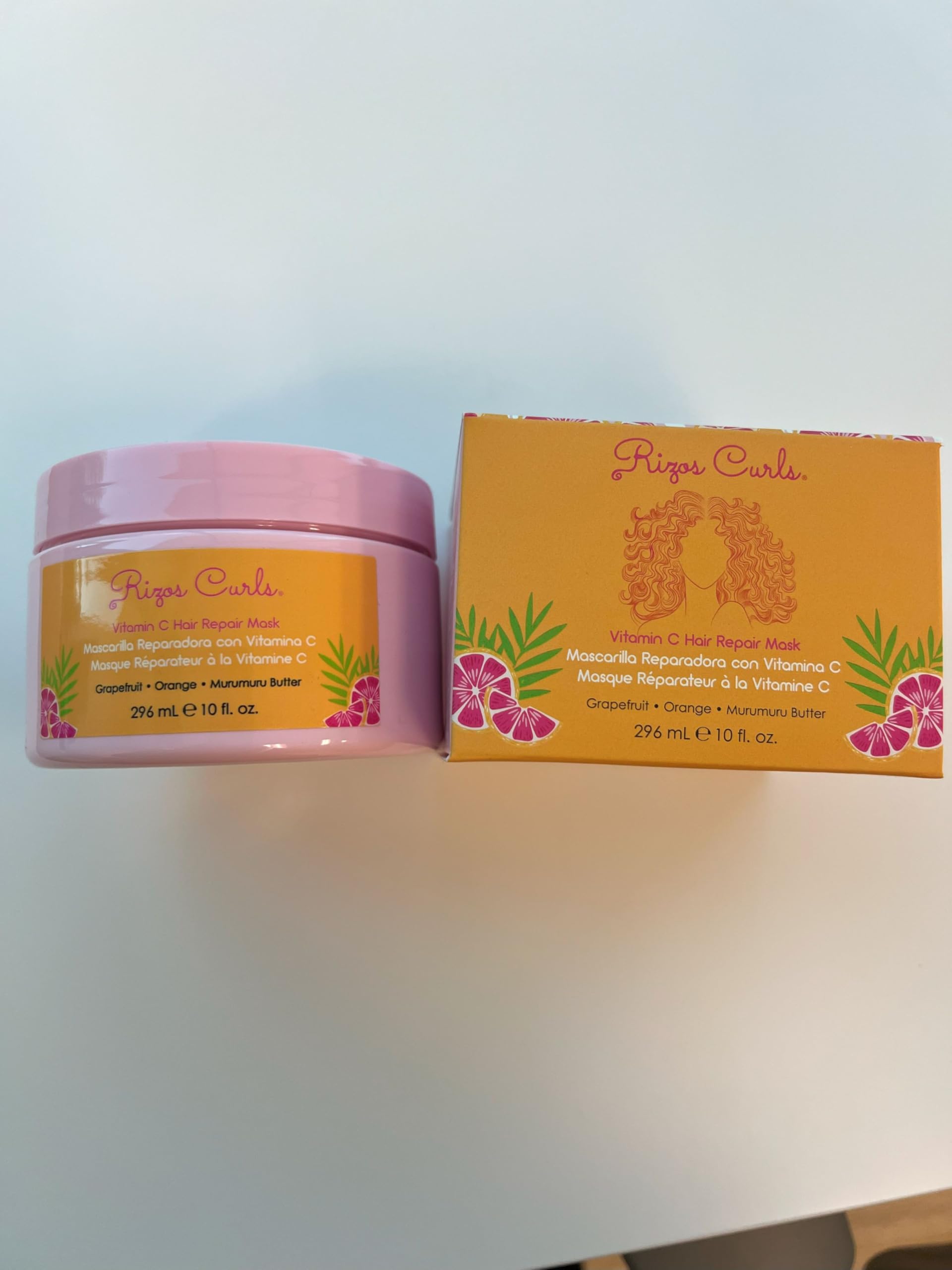 Rizos Curls Vitamin C Hair Repair Mask in-use moment shows frizz control potential.