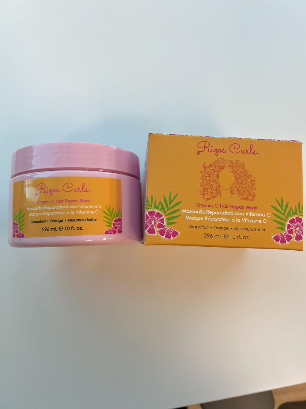 Rizos Curls Vitamin C Hair Repair Mask in-use moment shows frizz control potential.