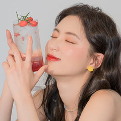 romnd Juicy Lasting Tint swatch on lips, warm coral-pink rose shade flattering many tones.