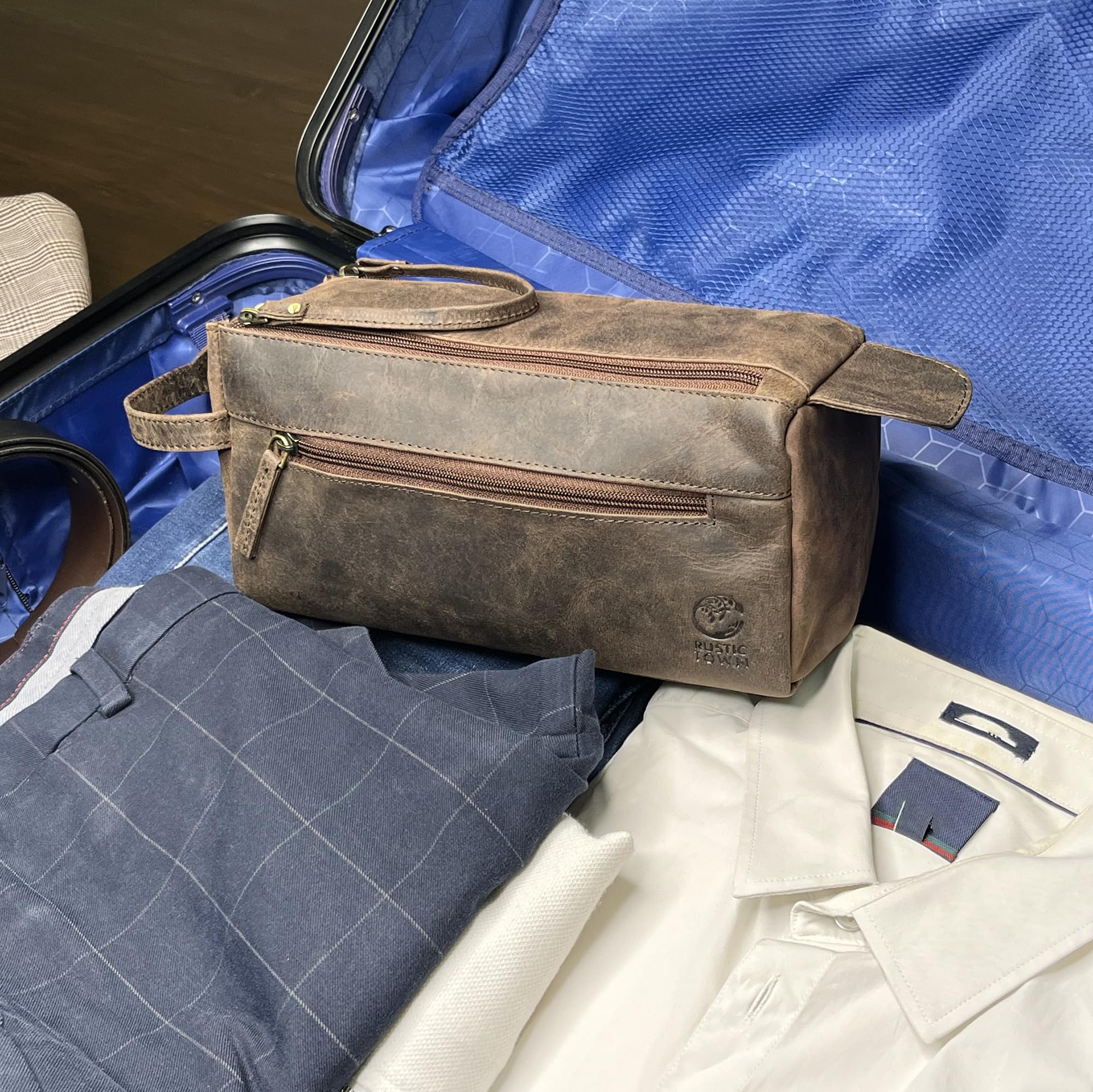 RUSTIC TOWN bag tucked in luggage demonstrates compact footprint ideal for carry-ons