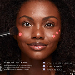 Saie Dew Liquid Blush being blended with finger showing quick seamless coverage benefit