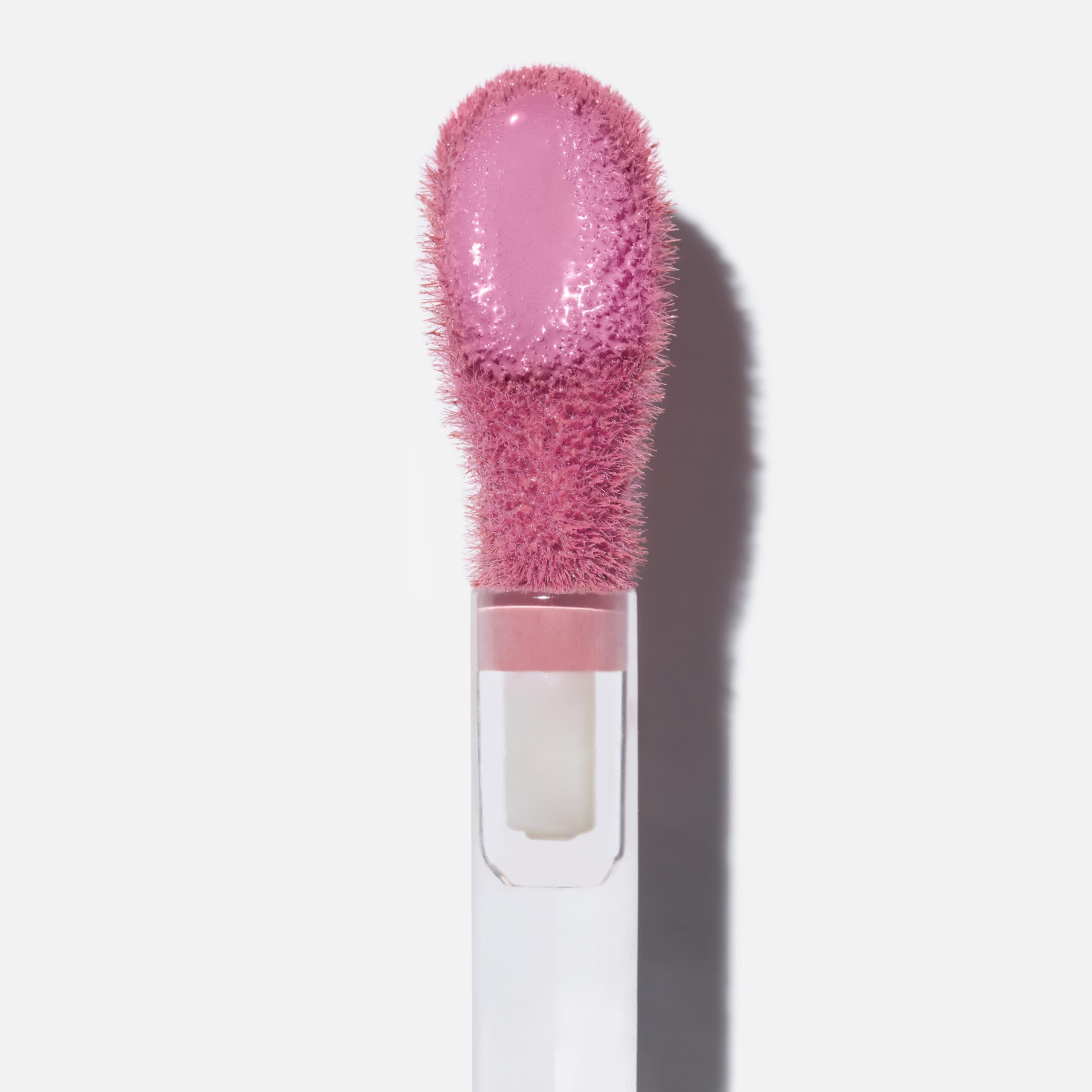 Saie Dew Liquid Blush blended with fingertips for seamless, dewy color.
