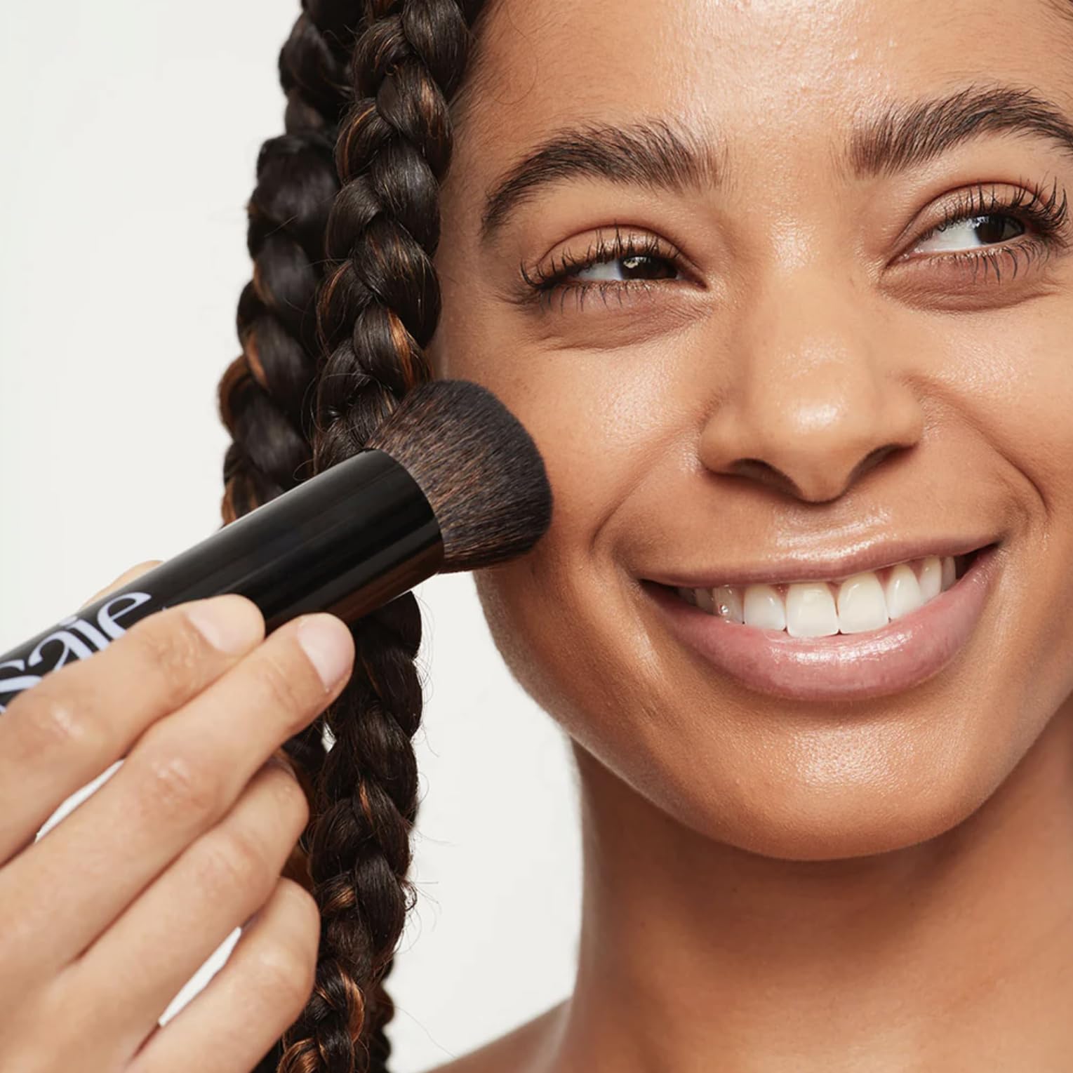 Saie Glowy Skin Tint demo with The Base Brush for even color distribution.