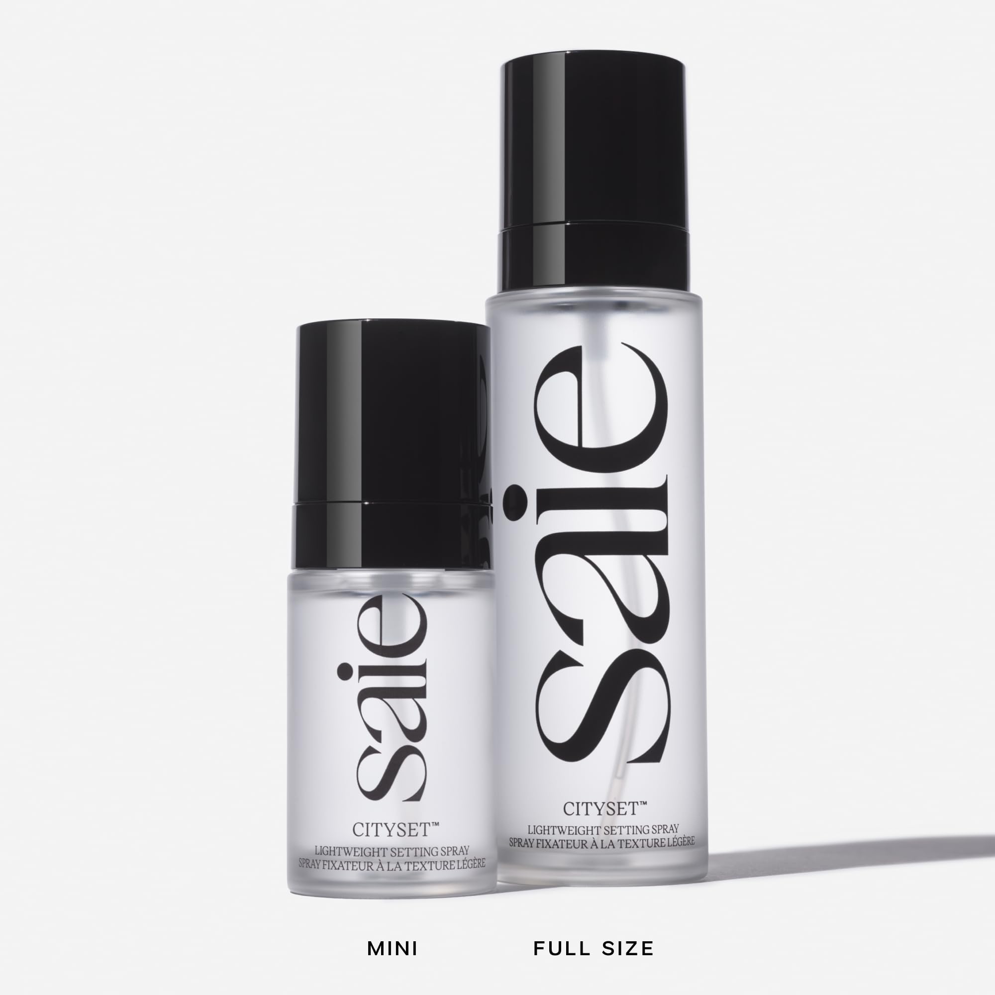 Person applying Saie mist outdoors showing long-lasting makeup refresh benefit