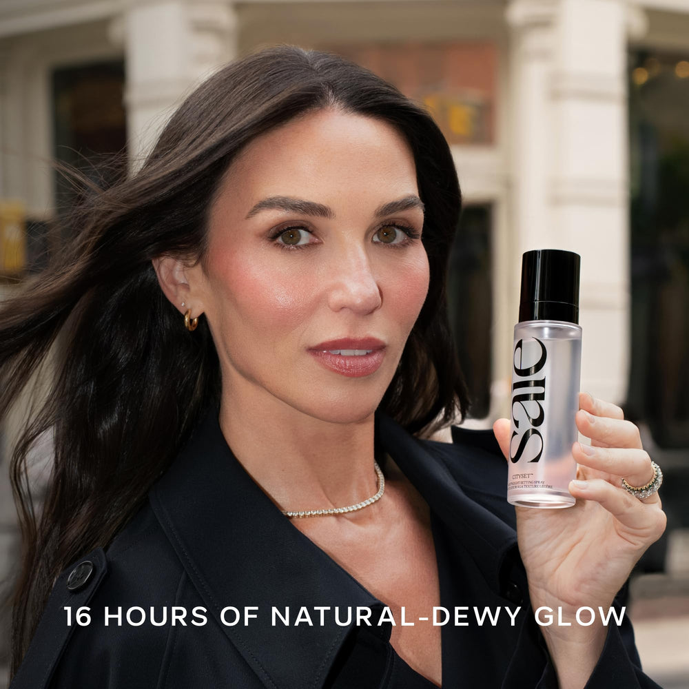 Saie spray landing on cheek to show hydrating dewy finish benefit