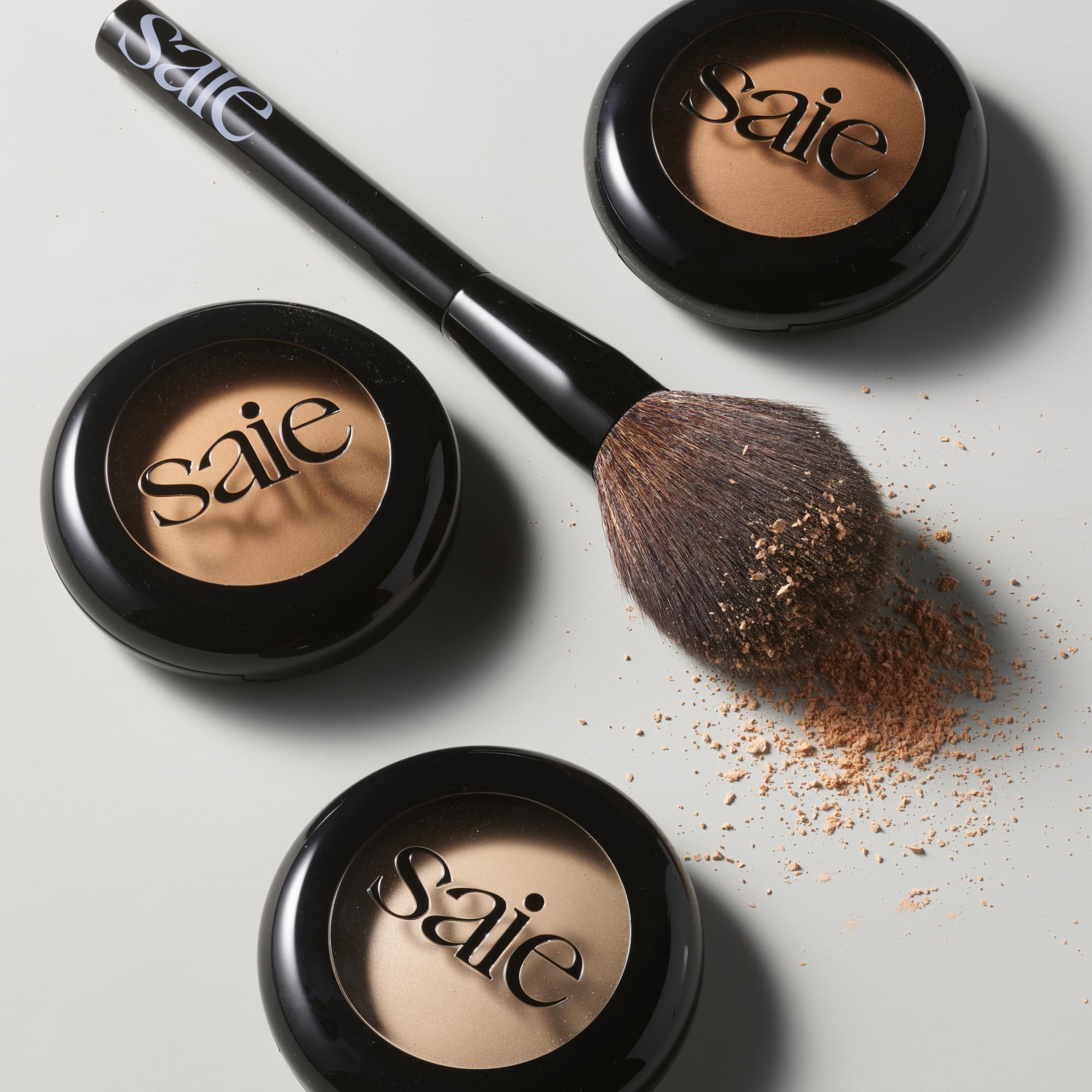 Saie brush held in hand to show scale and effortless coverage