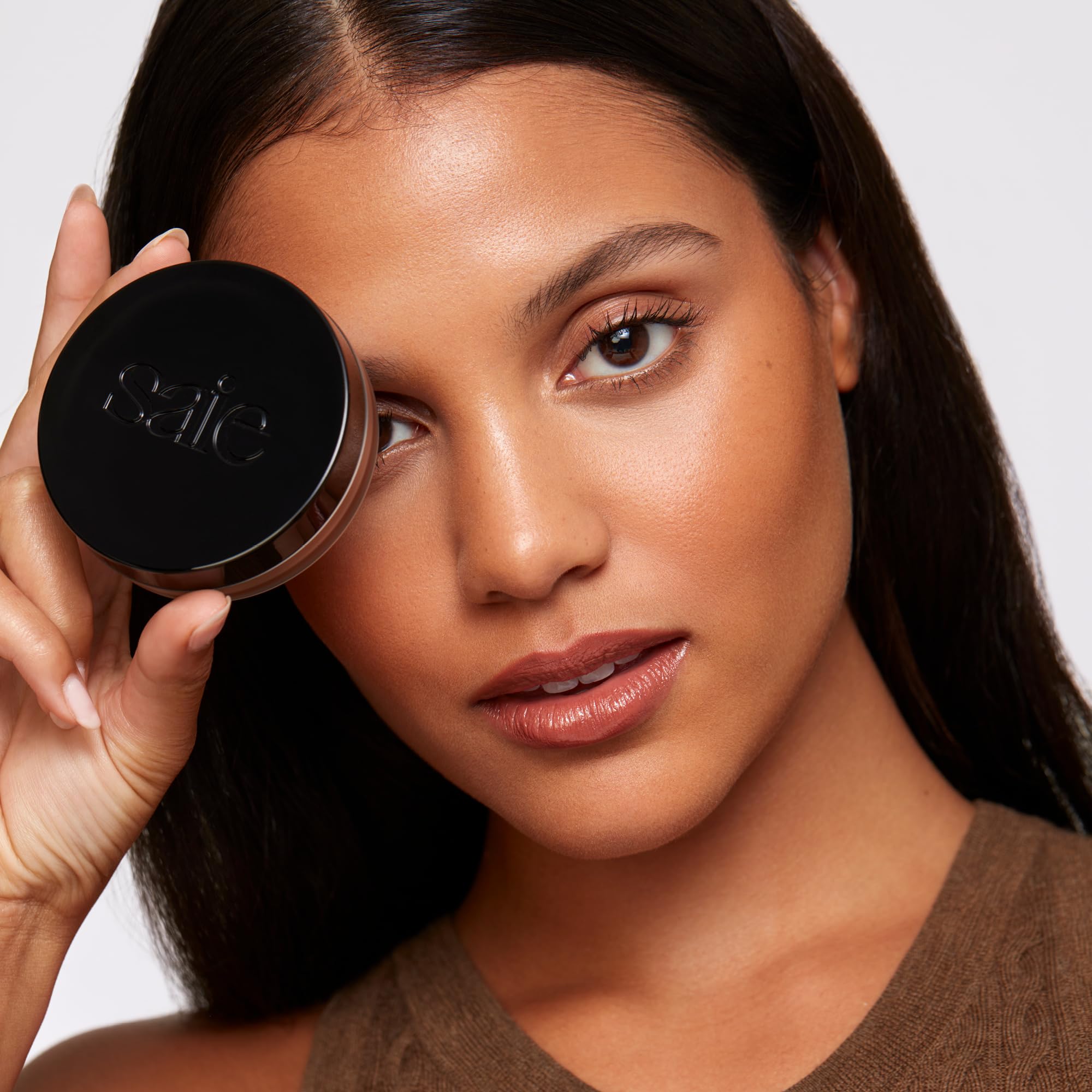 Saie Sun Melt bronzer brush application scene highlighting easy blending