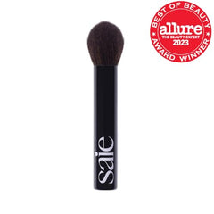 Saie The Fluffy Brush in hand demonstrates ergonomic grip for easy on-the-go touch-ups.