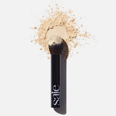 Saie The Fluffy Brush tapered-tip for pinpoint powder placement on high-shine zones.