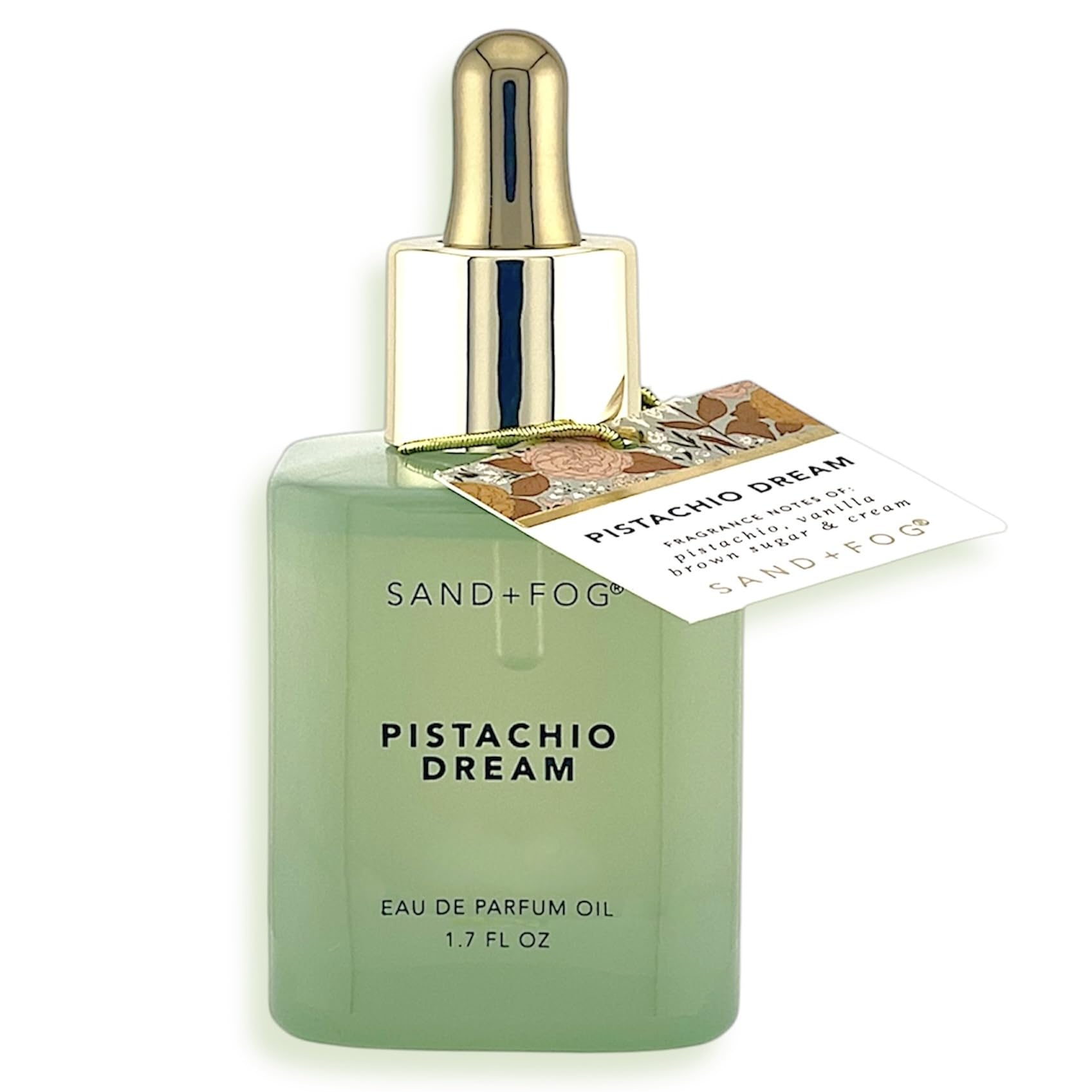 Sand + Fog Pistachio Dream bottle on mint-green glass for luxurious vanity presentation.