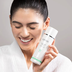 Sanitas Lemon Cream Cleanser ingredients bottle highlights vitamin C, jojoba oil, and butters.
