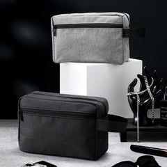 Sanwuta dark blue toiletry bag showing side handle for easy grab-and-go travel.