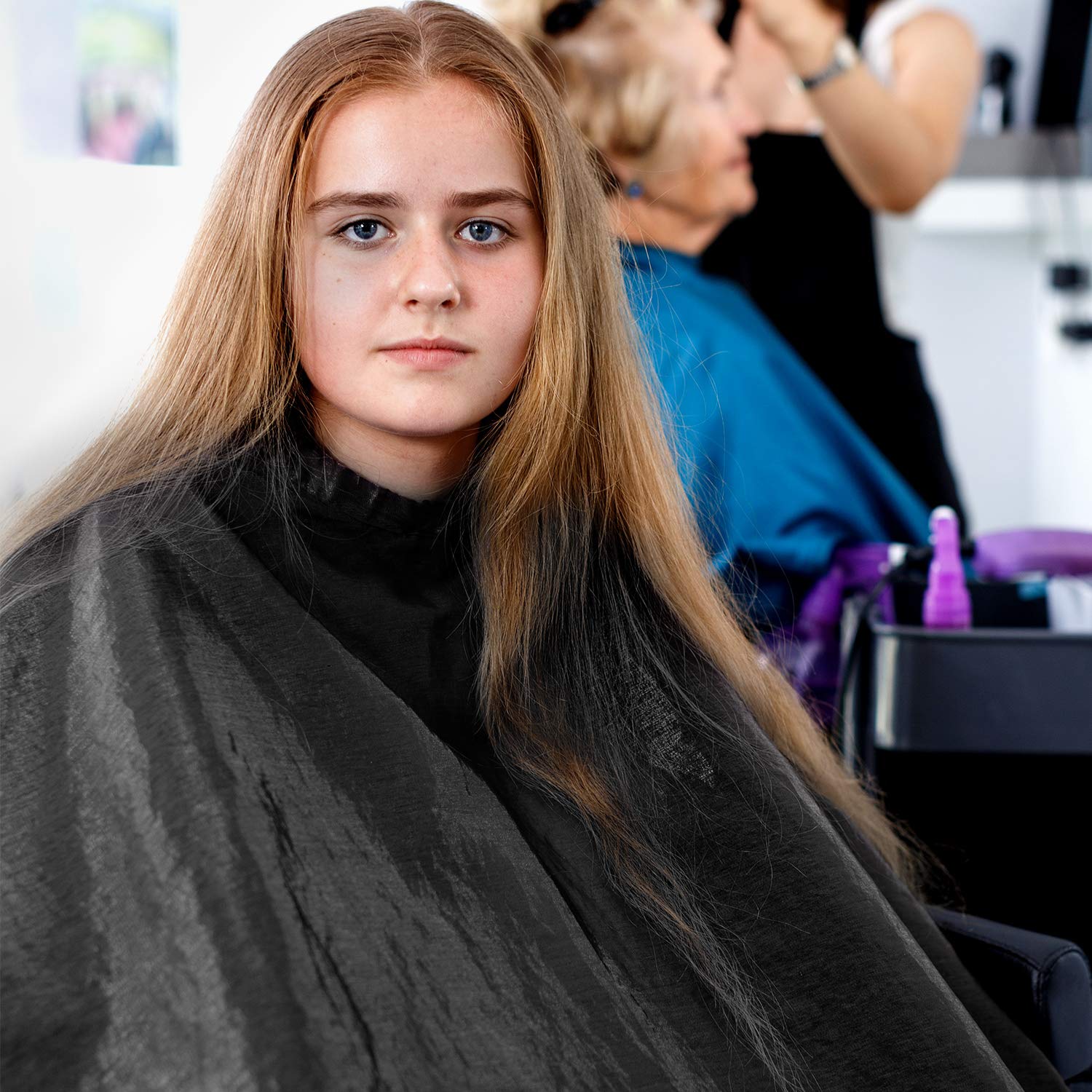 SATINIOR adjustable snap-closure cape during haircut demonstrates secure fit
