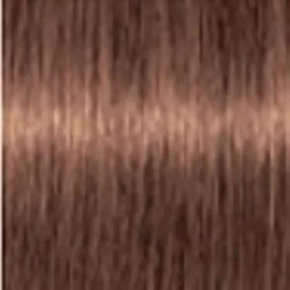 Schwarzkopf Igora Royal color creme 7-57 tube in use showing precise application for even tone and gray coverage.