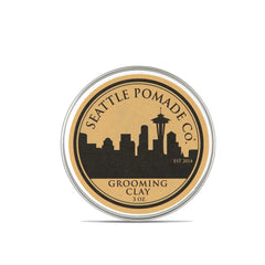 Seattle Pomade Co. Grooming Clay jar closeup shows beeswax-based hold for all-day manageability.