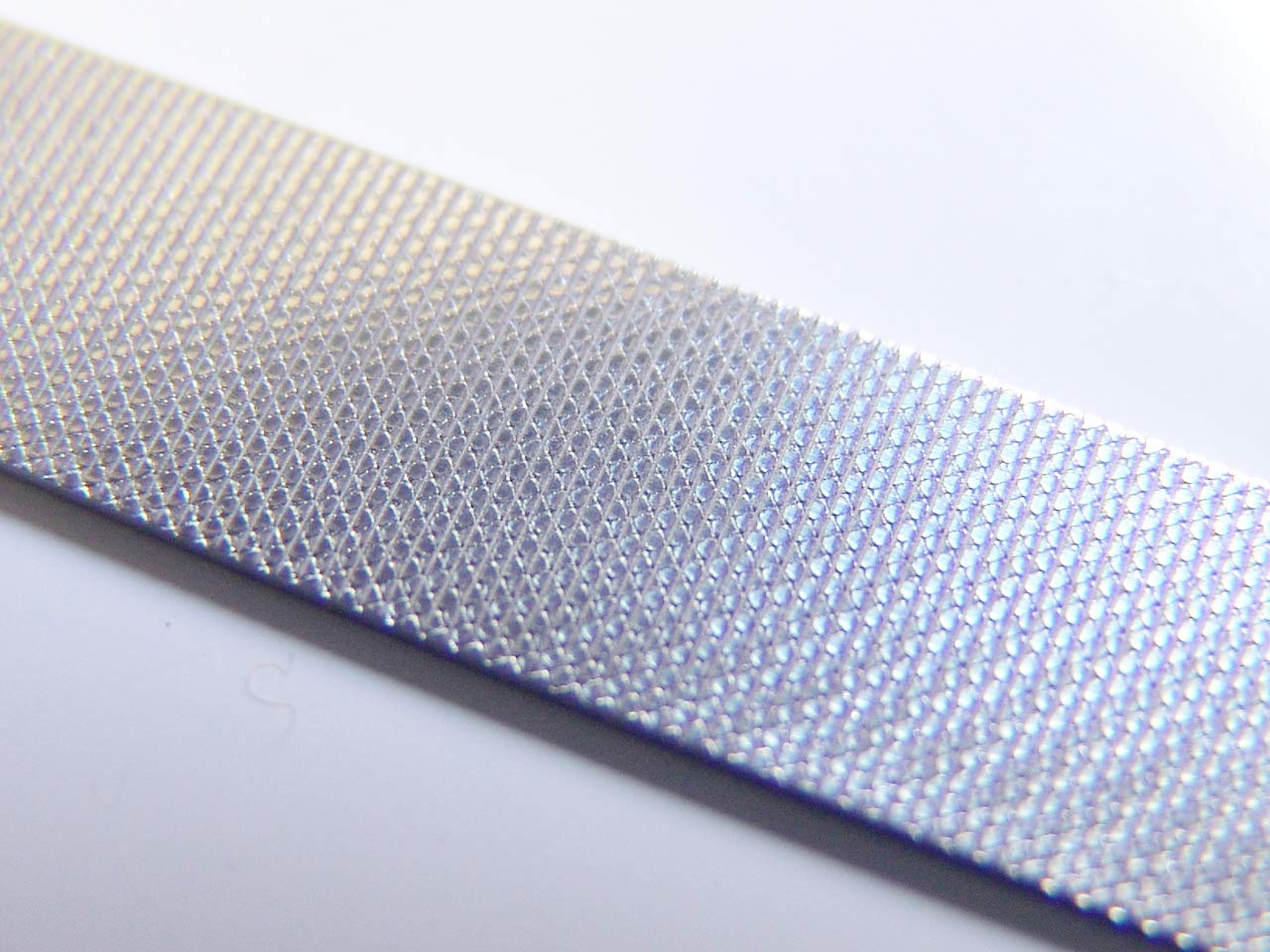 Seki Edge SS402 etched nail file side for fast shaping and smoothing.