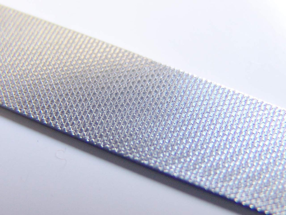 Seki Edge SS402 etched nail file side for fast shaping and smoothing.
