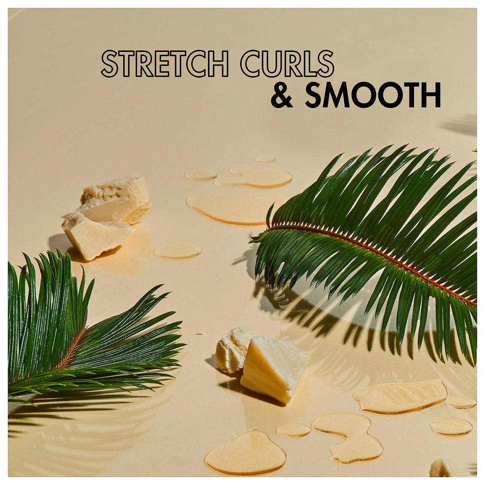 Frizz-control result from SheaMoisture Curl Stretch Pudding for smooth finish.