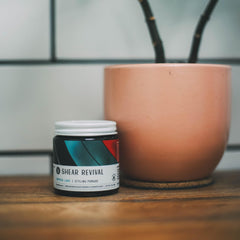 Shear Revival Crystal Lake pomade hands rubbing, highlighting easy application for textured looks