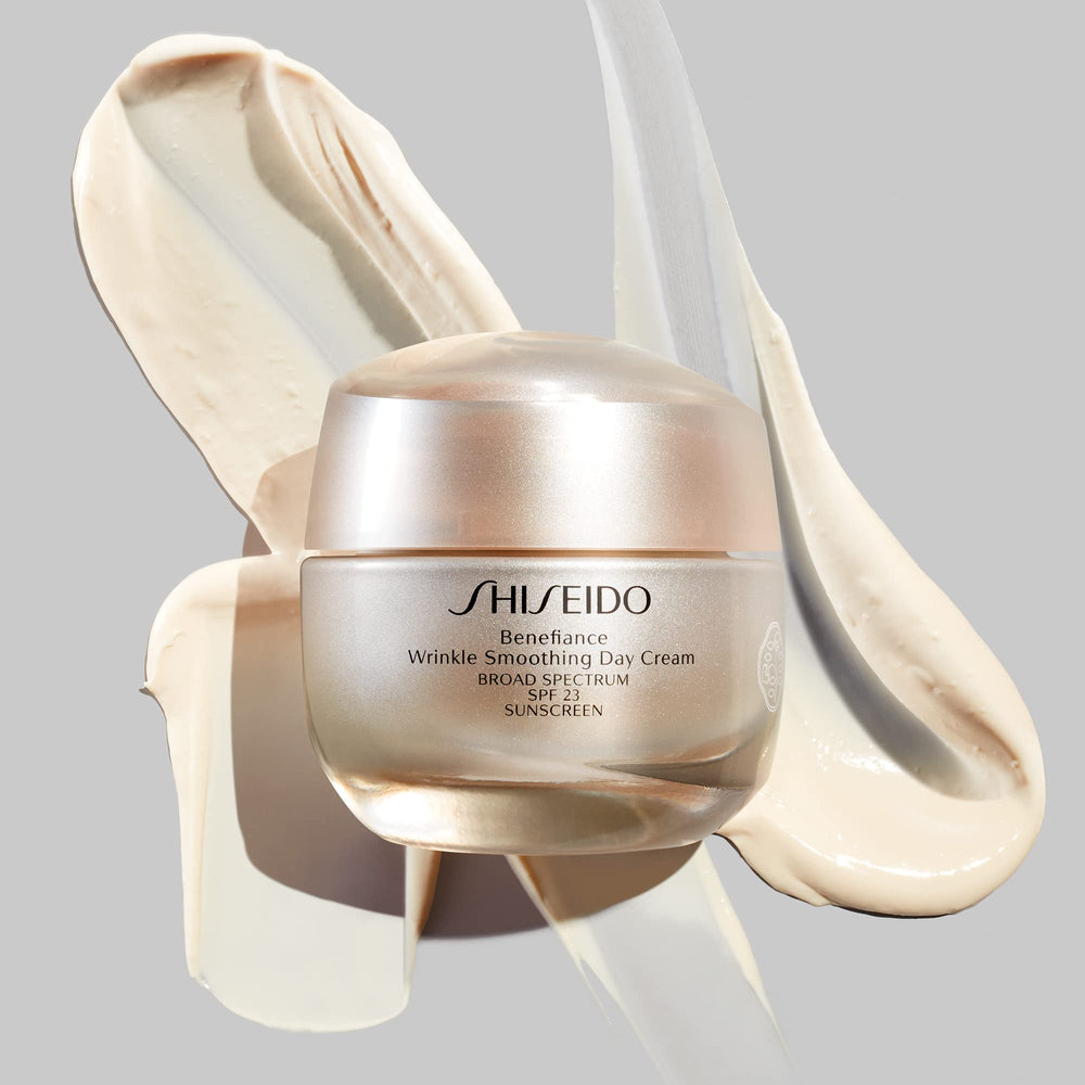 Shiseido Benefiance day-cream being applied along jawline shows 24-hour hydration and protection.