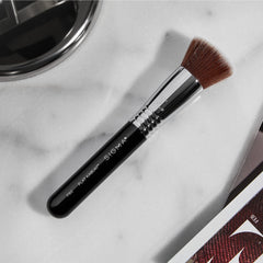 Sigma Beauty F85 airbrush kabuki brush in use with foundation on skin