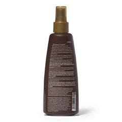 Silk Elements Megasilk Olive Heat Protection Spray being applied for lightweight, alcohol-free styling.