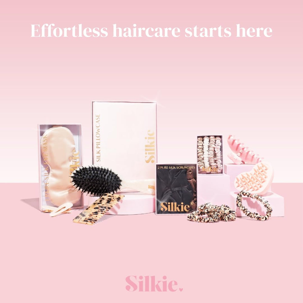 Silkie noir scrunchies in hand as a compact, portable haircare solution.