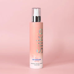 Sleek'e Hair Silk'e Detangler Spray being used on tangled hair for gentle detangling.