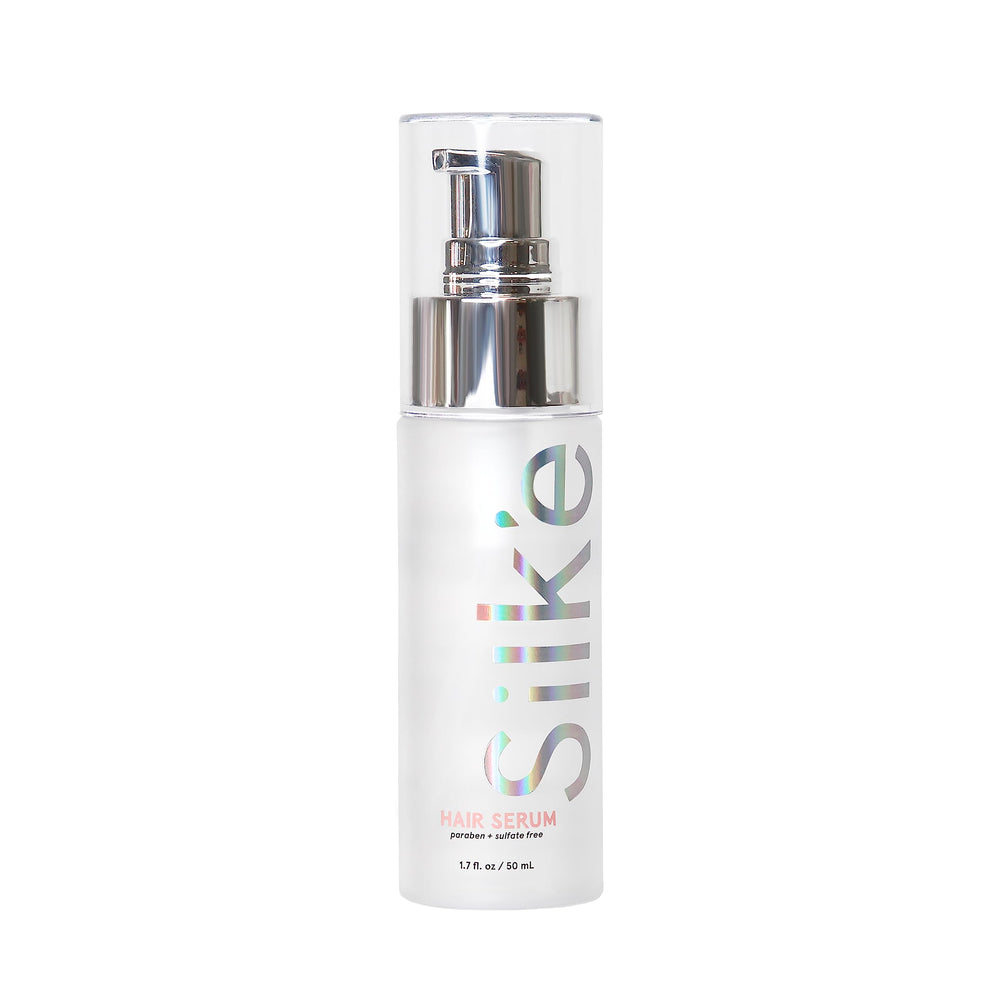Sleek'e Silk'e Hair Repair Therapy Serum bottle closeup shows frizz-control for smoother styling.