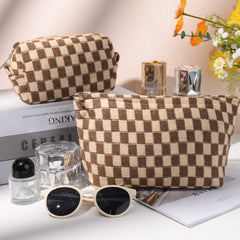 SOIDRAM checkered canvas makeup bag in brown tones for organized makeup storage.
