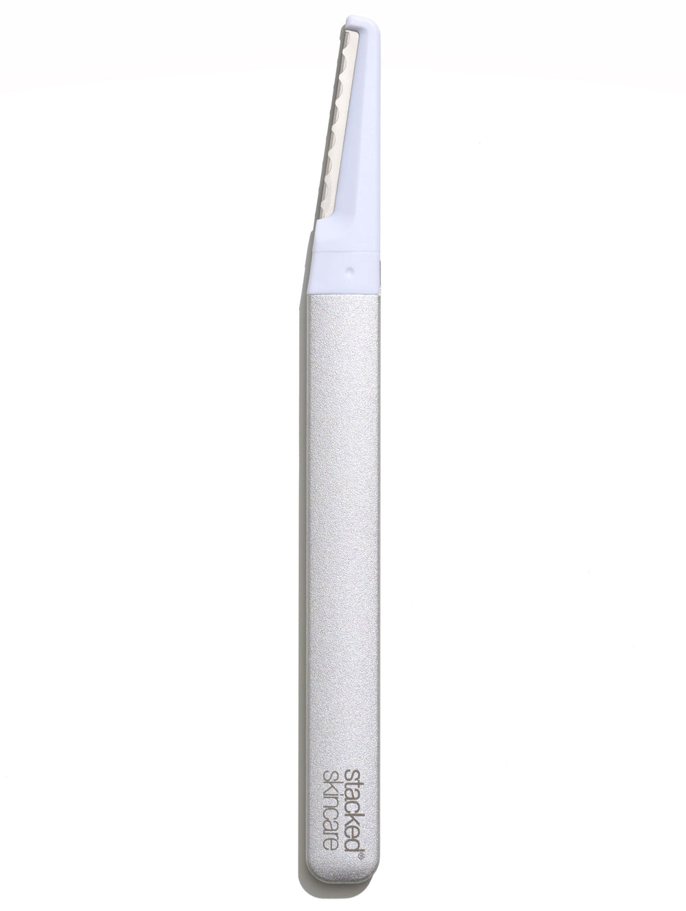 StackedSkincare dermaplaning tool with metal handle for precise at-home exfoliation and peach fuzz removal.