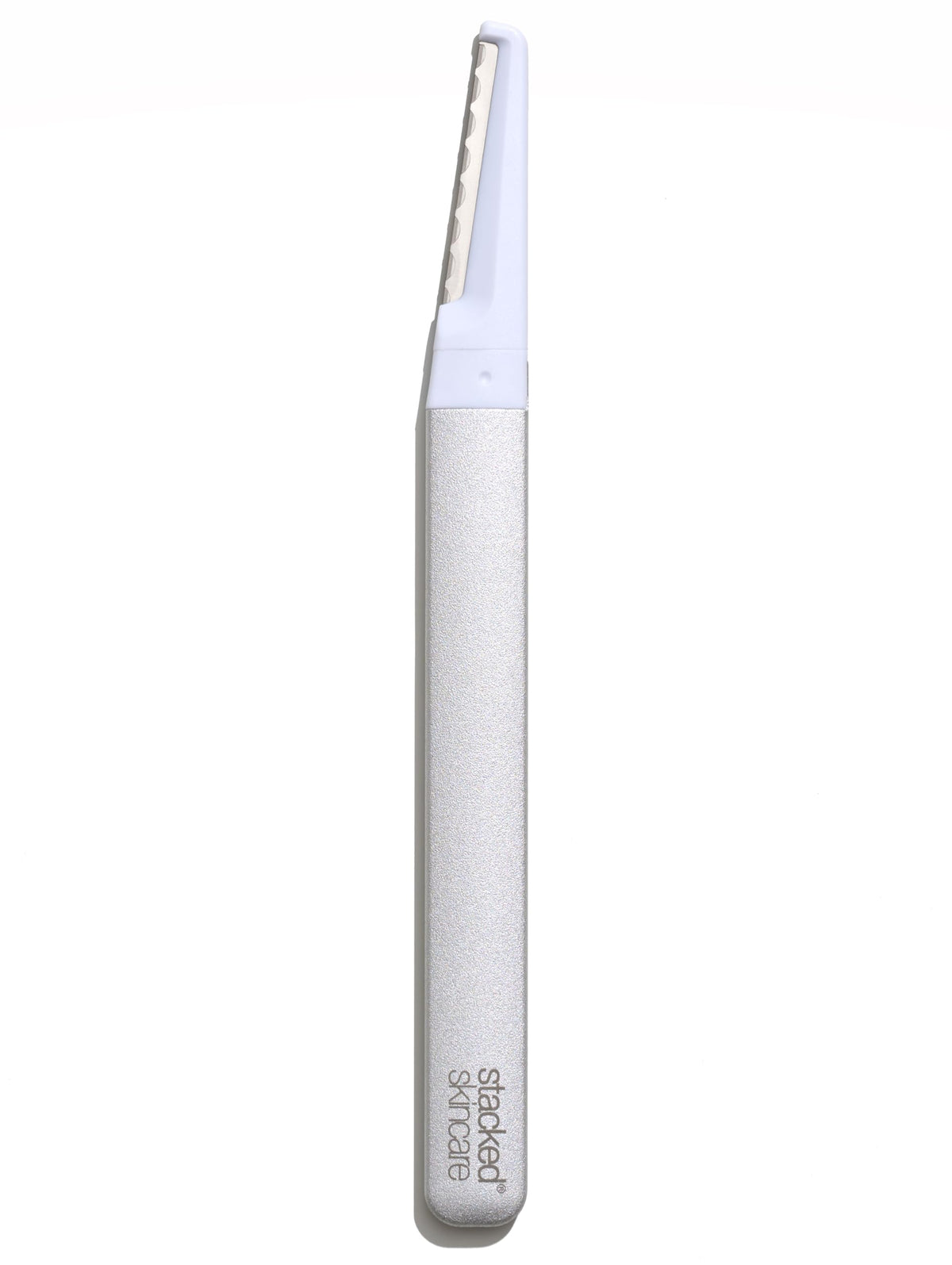 StackedSkincare dermaplaning tool with metal handle for precise at-home exfoliation and peach fuzz removal.