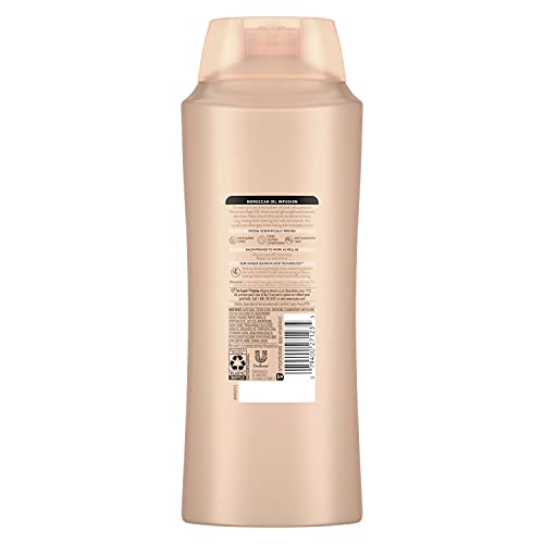 Squeezing Suave Moroccan Infusion conditioner for smooth hair.