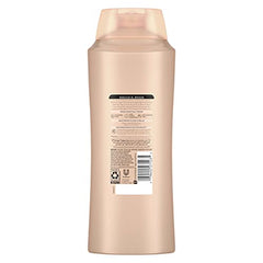 Squeezing Suave Moroccan Infusion conditioner for smooth hair.