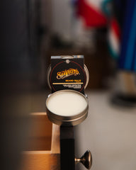 Suavecito beard balm being applied to the beard from root to tip
