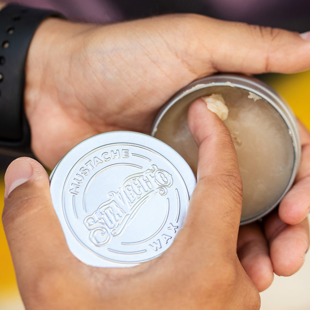 Travel-size Suavecito Mustache Wax tin ready for quick touch-ups away from home.