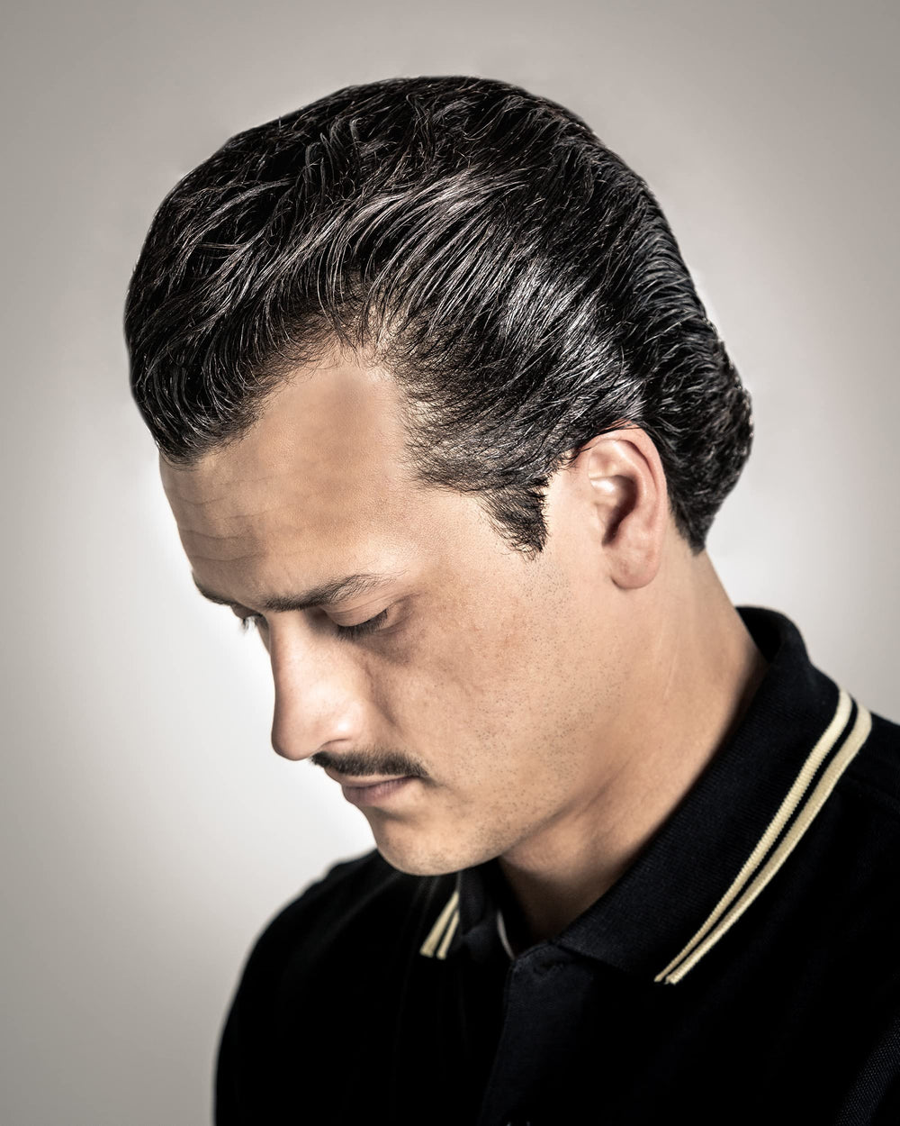 Suavecito Oil Based Pomade jar side view highlights high shine and pliable hold.