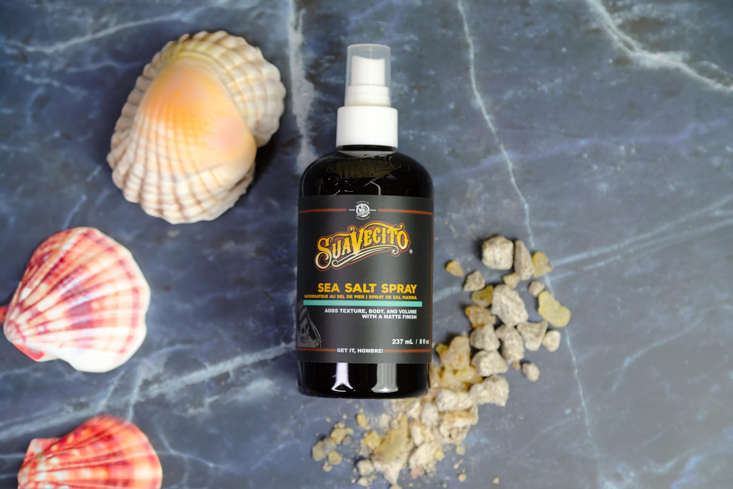 Hands applying Suavecito Sea Salt Spray for easy texture and volume.