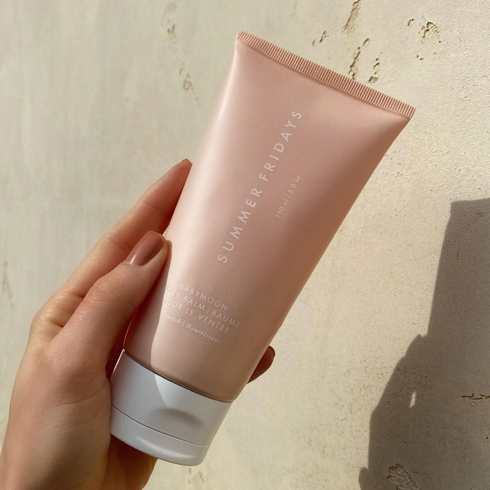 Summer Fridays Babymoon Belly Balm being applied to dry belly skin.