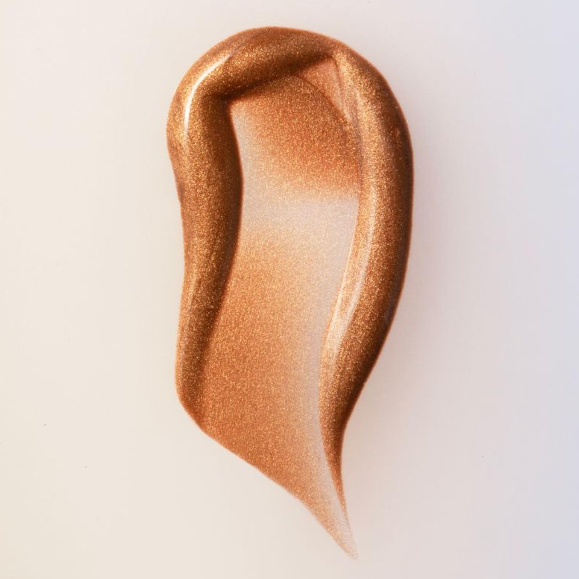 Summer Fridays Bronzing Drops being dispensed, ready to mix into skincare for a bronzed glow