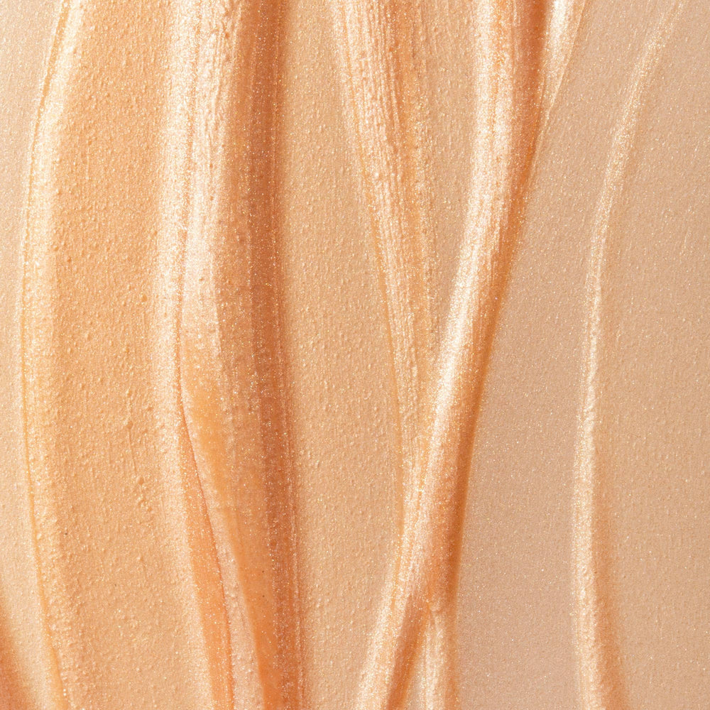 Summer Fridays Illuminating Drops on bare skin for a glass-skin effect.
