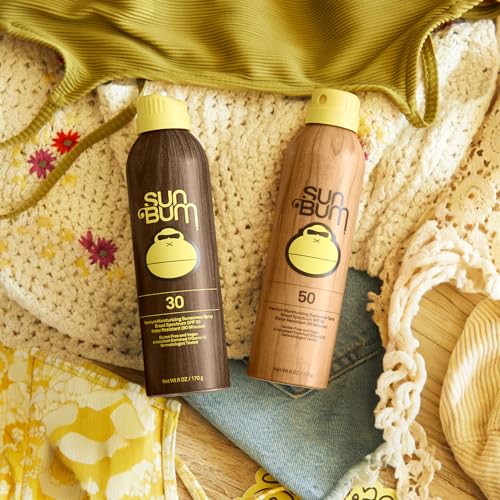 Sun Bum Original SPF30/50 spray mist application demonstrates easy outdoor reapplication.