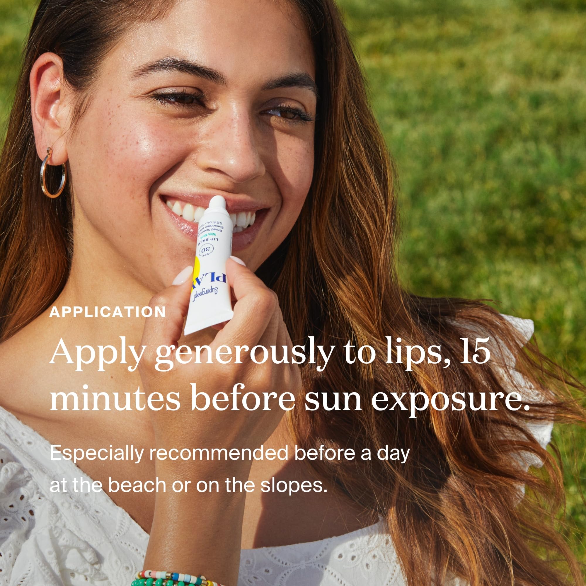 Supergoop PLAY lip balm SPF30 on a sunny beach day shielding lips outdoors