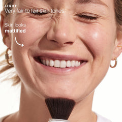 Supergoop! Re(setting) Mineral Powder Light being applied to the face.