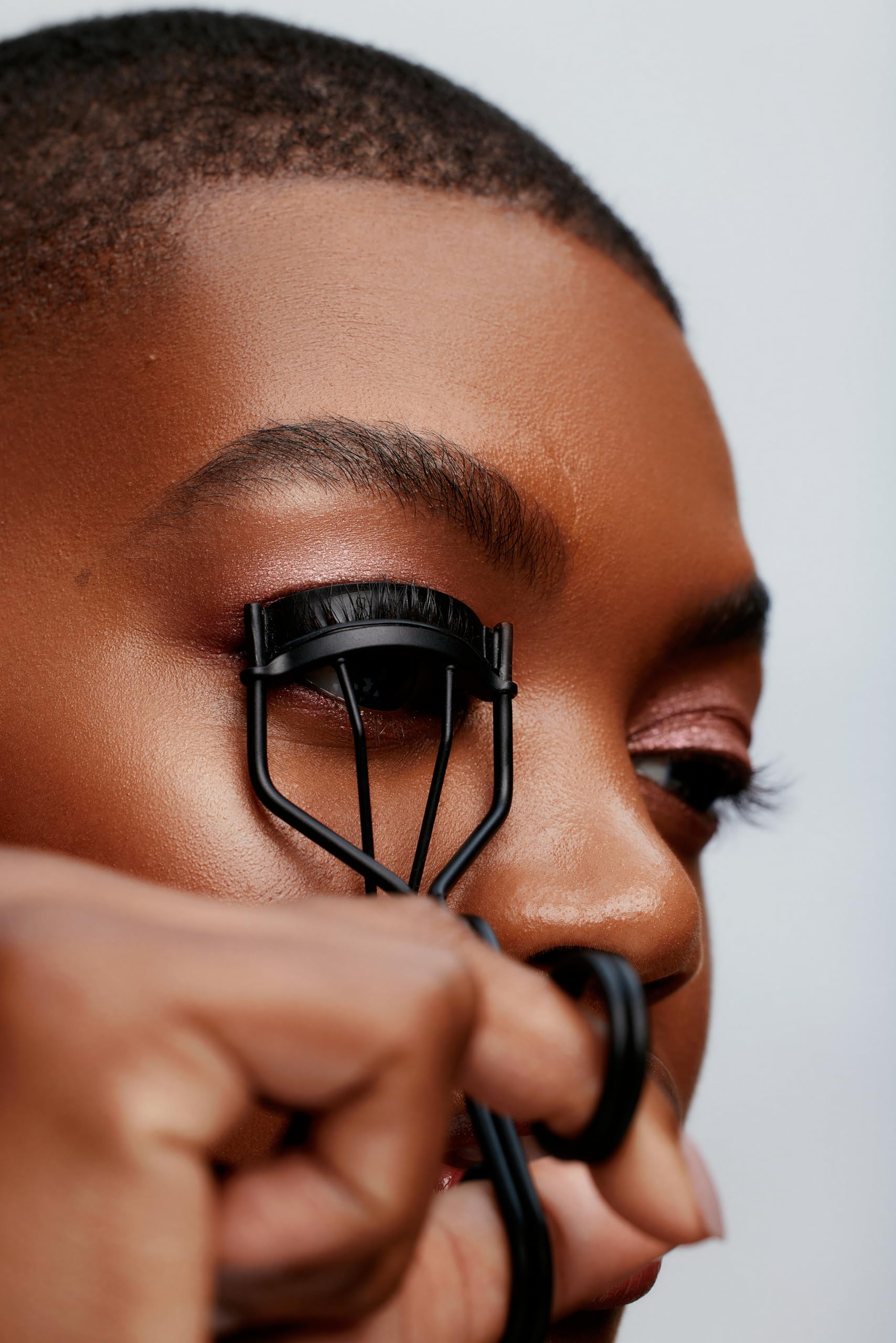 Surratt Relevee Lash Curler in compact case for travel-friendly precise curling.