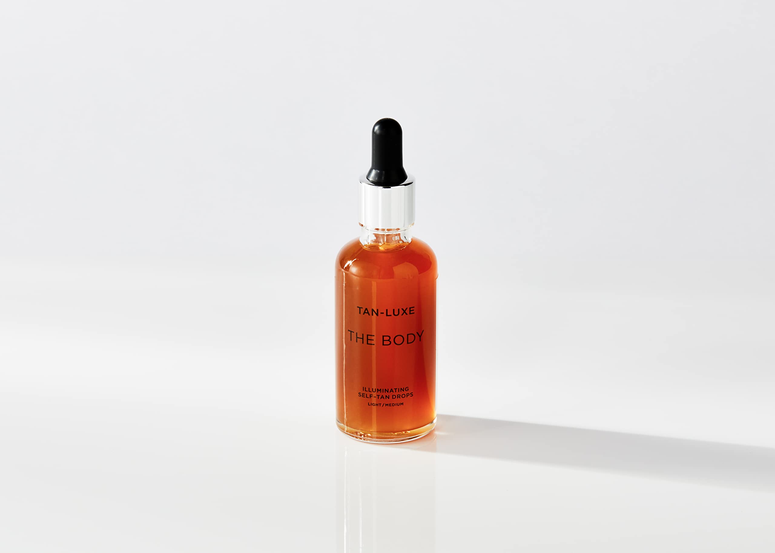 Tan-Luxe Self-Tan Drops dropper-application demonstrating easy, precise mixing for gradual color.