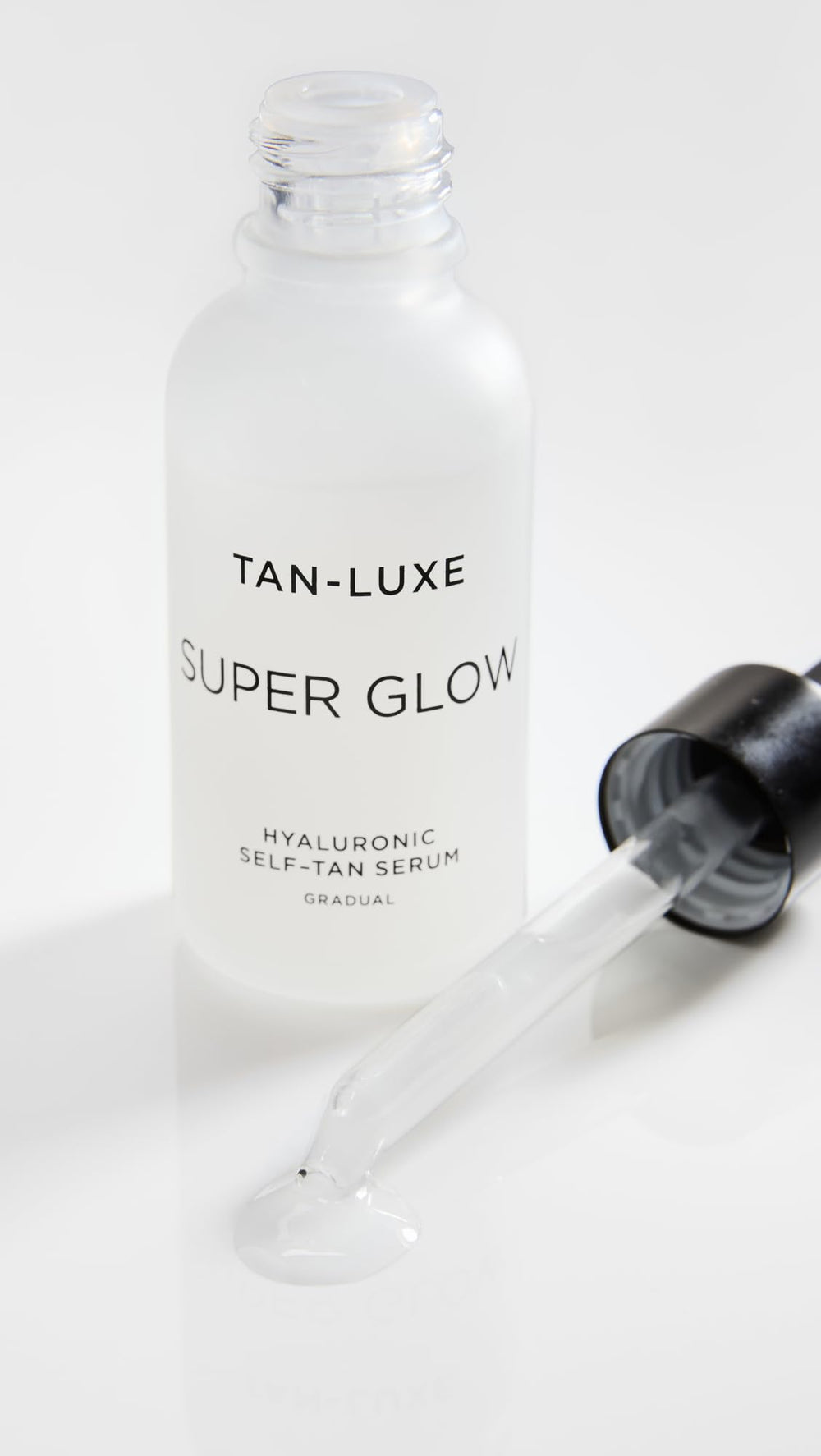 TAN-LUXE Super Glow packaging closeup showcases cruelty-free vegan formula and naturally derived DHA