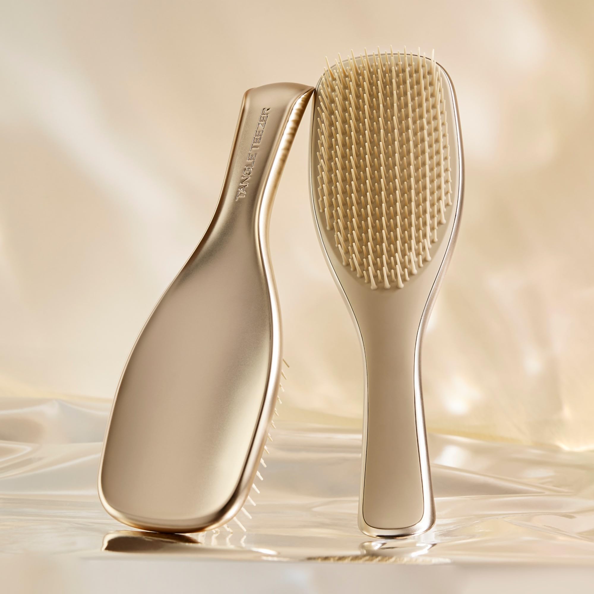 Tangle Teezer Chrome Ultimate Detangler teeth close-up shows two-tiered teeth for gentle detangling.