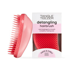 The Tangle Teezer Original Detangler Pink Punch shown on hair section for smooth detangling.